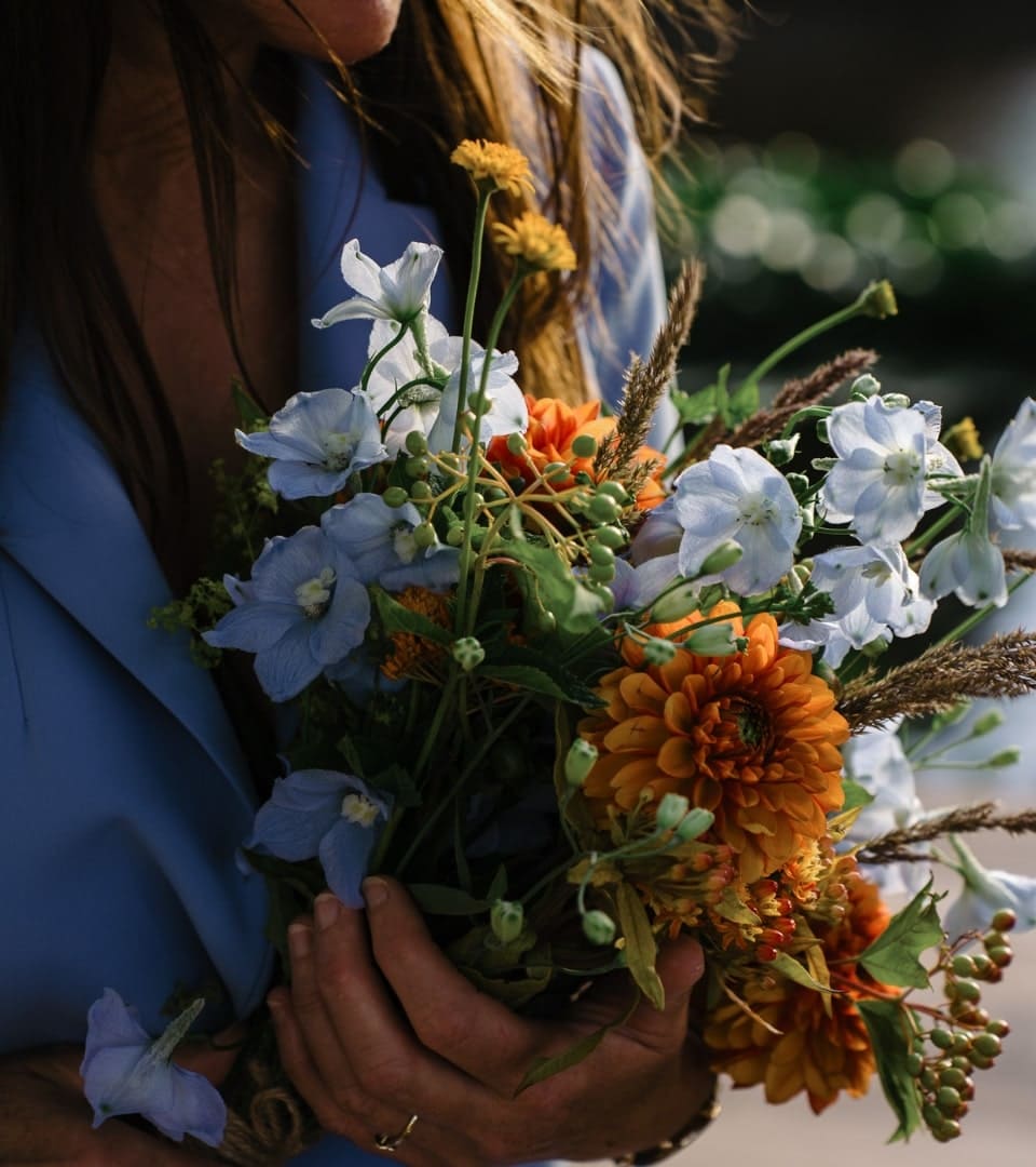 A young lady is holding flowers